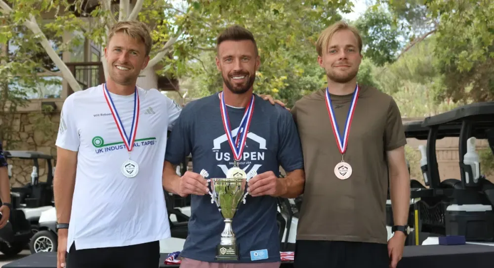James Hardy holds the U.S. Speedgolf Open trophy between Will Robson and Carl Palmberg.