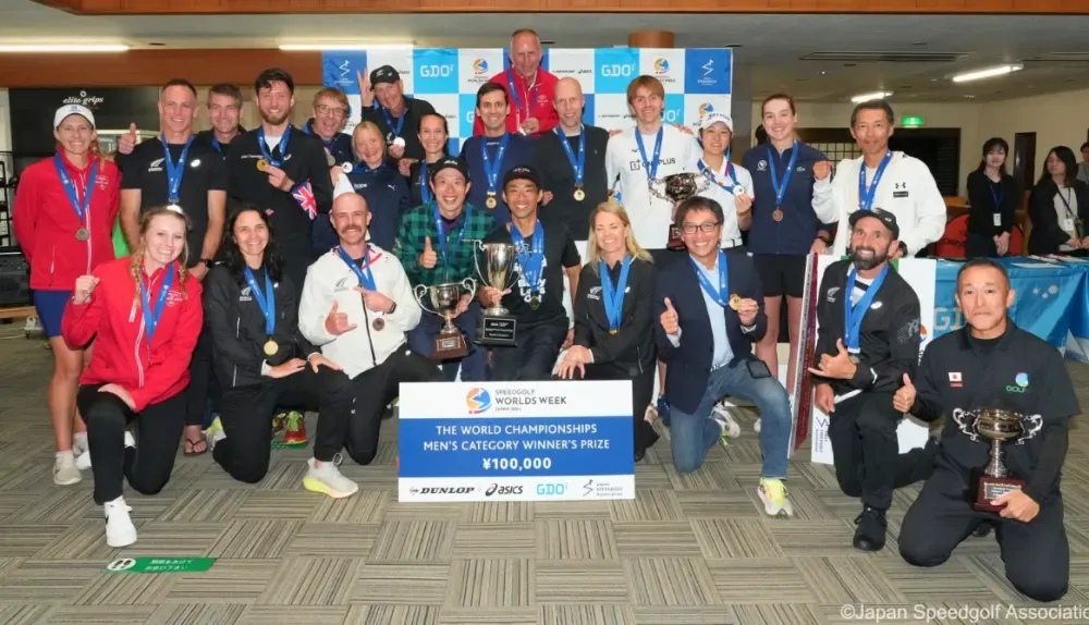 Speedgolf World Championships competitors pose with medals and trophies beneath a men's category prize sign.