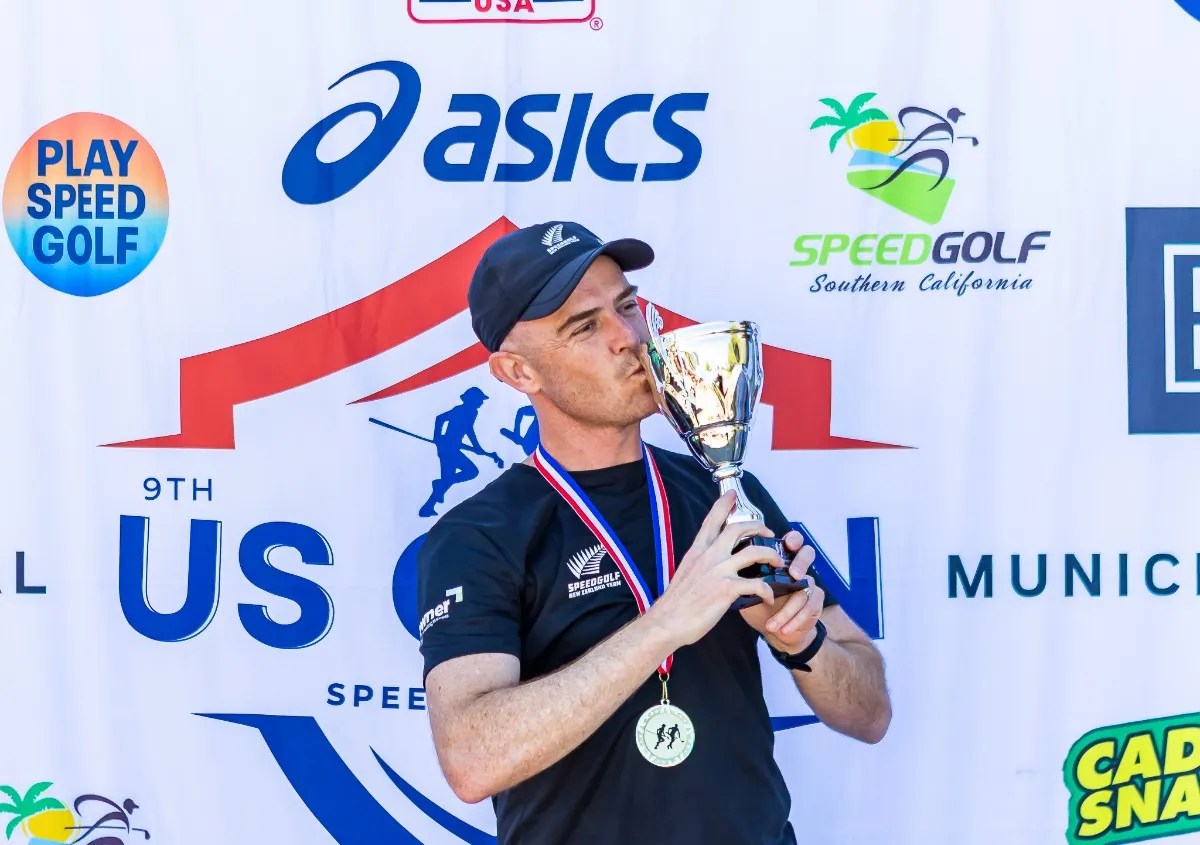 Robin Smith kisses the trophy after winning the ninth U.S. Speedgolf Open.