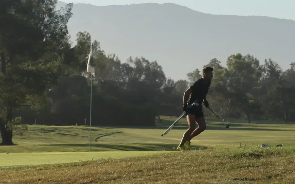 James Hardy runs beside a green at Temecula Creek Inn during the U.S. Speedgolf Open.