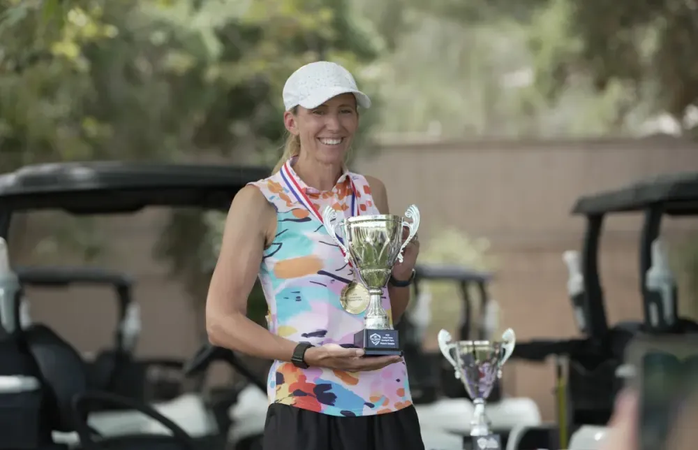 Lauren Cupp holds the U.S. women's speedgolf trophy.