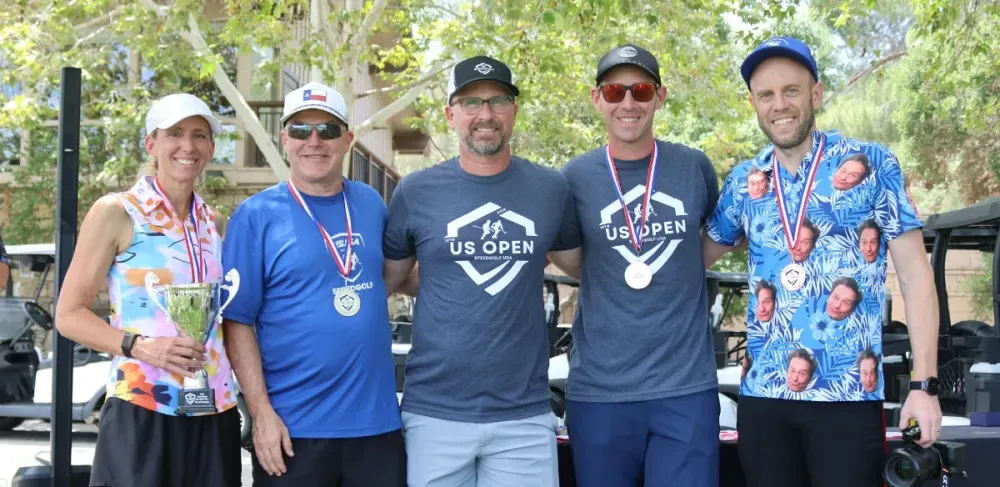 Lauren Cupp, Paul Kivela, Nic Goodin, and Kyle Peyton pose with U.S. Open medals and event staff.