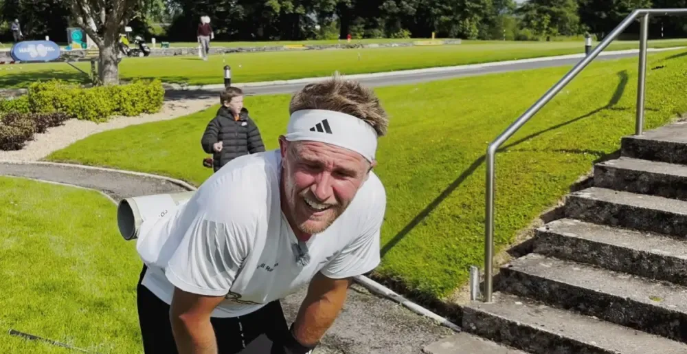 Speedgolfer resting near steps at Castlebar Golf Club